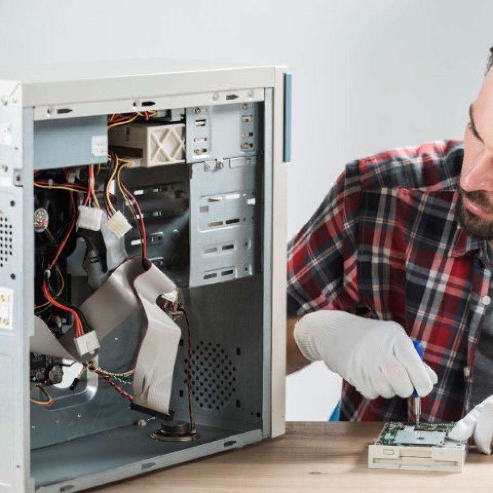 male-technician-working-broken-computer